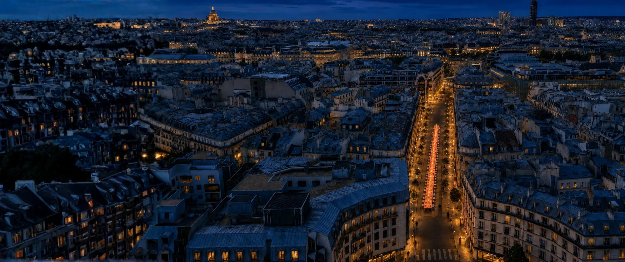 Night aerial view of Paris with a single glowing table running the length of Rue du Pont-Neuf